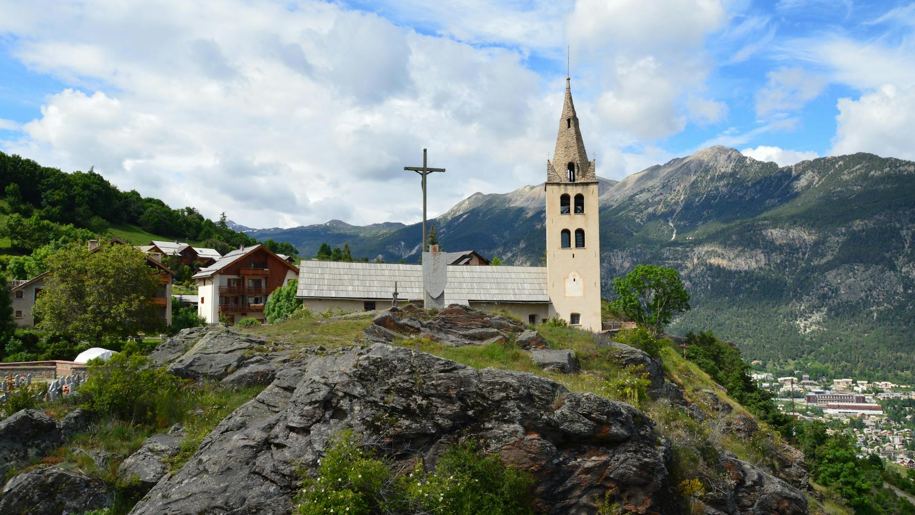 church on hill over valley in mountains