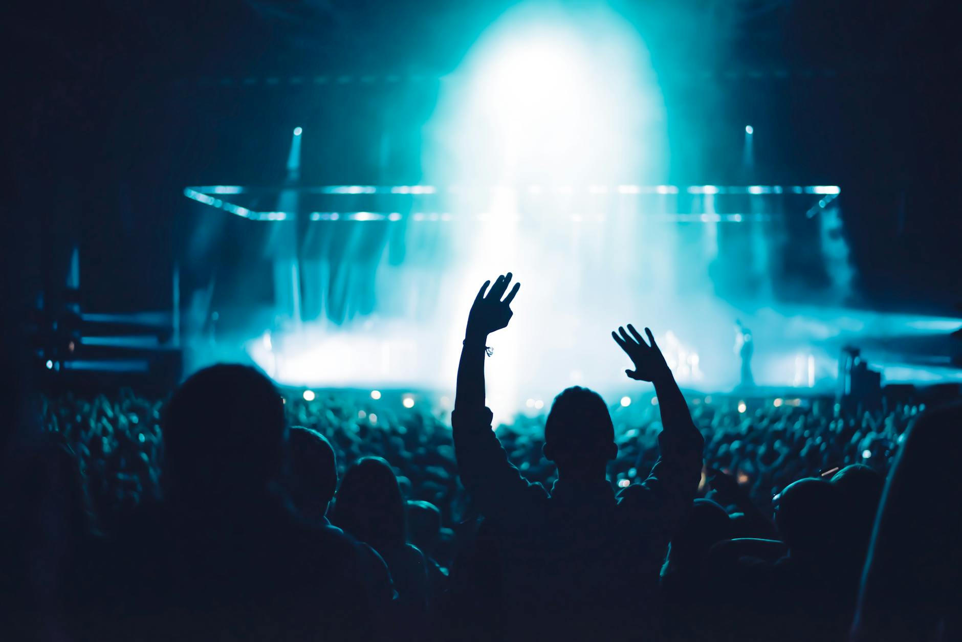 silhouette of people in front of stage