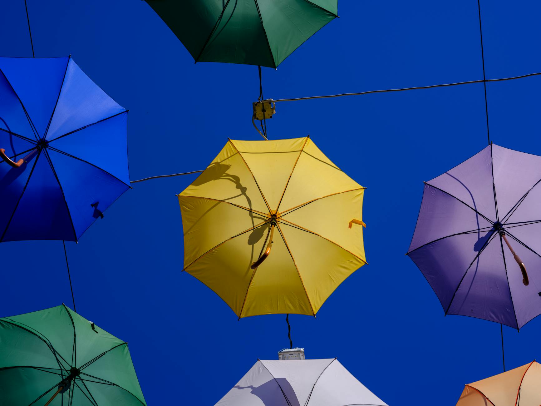 colorful umbrellas against clear blue sky