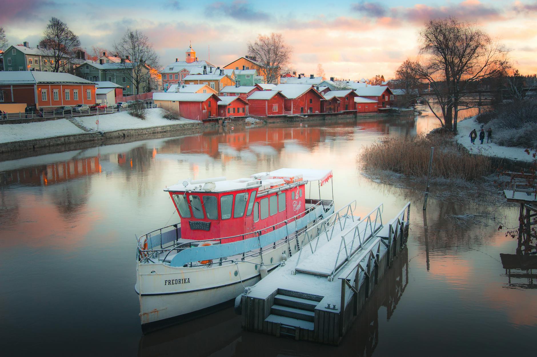 white boat on water near houses