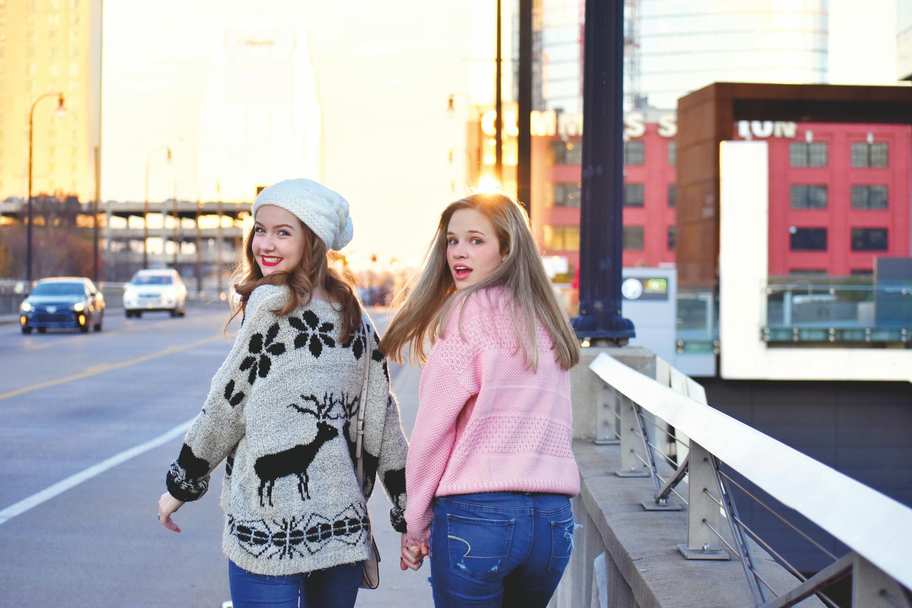 photograph of girls in sweaters holding hands