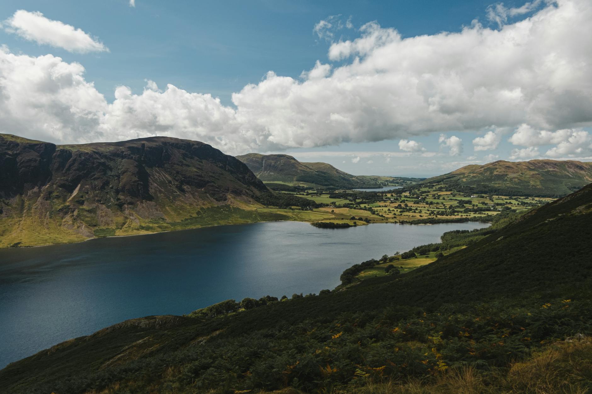 river amidst hills on cloudy day